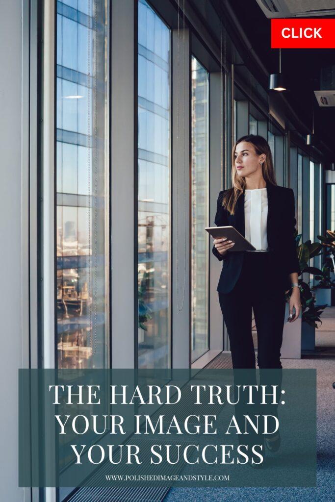 A woman walks along the side of an office looking out the window.