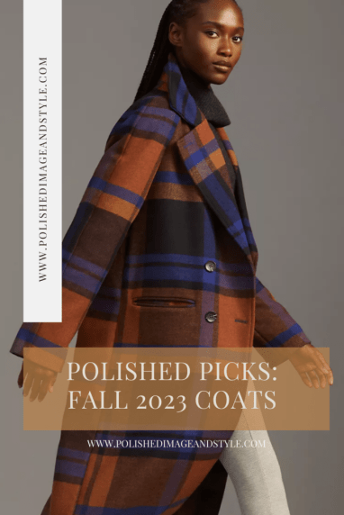 A woman walks by wearing a plaid winter coat with orange, brown, and blue coloring.