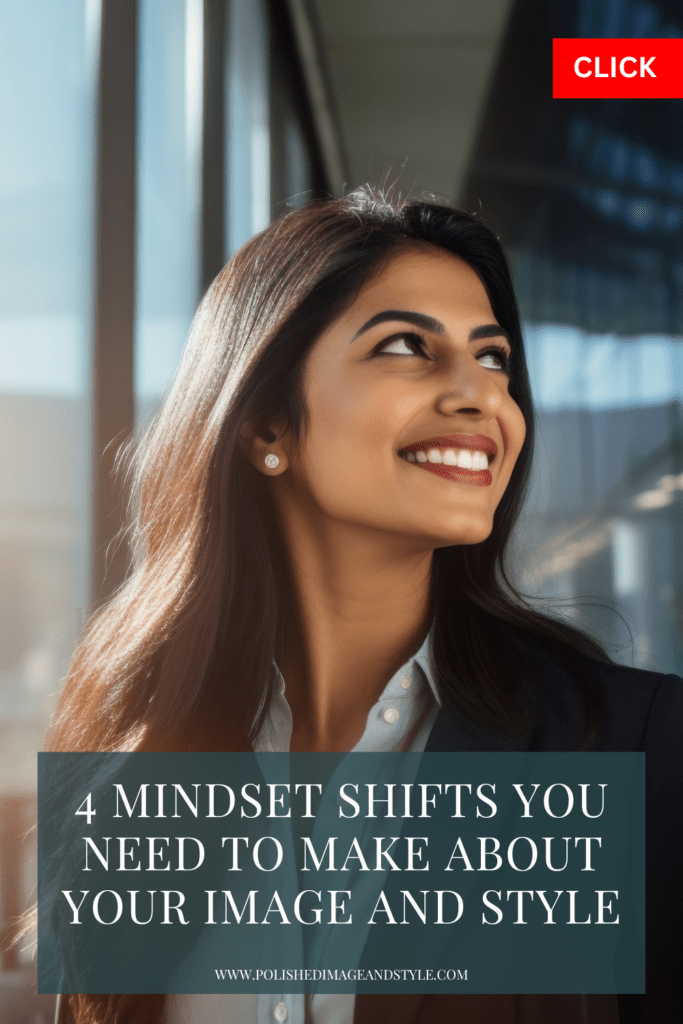 Woman looks up to the left while smiling in a corporate outfit. 